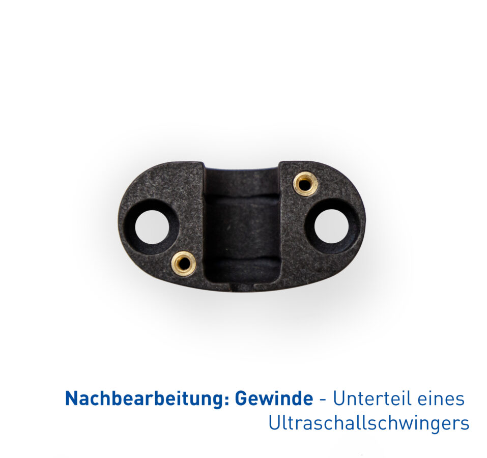 Gezeigt wird das Unterteil eines Ultraschallschwingers, in das metallische Gewindeeinsätze als Nachbearbeitungsschritt integriert wurden.